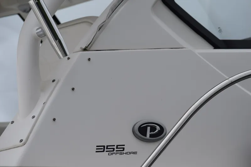 Slide: The Image of 2022 Pursuit OS 355 Offshore boat detail with logo and sleek design. - 460