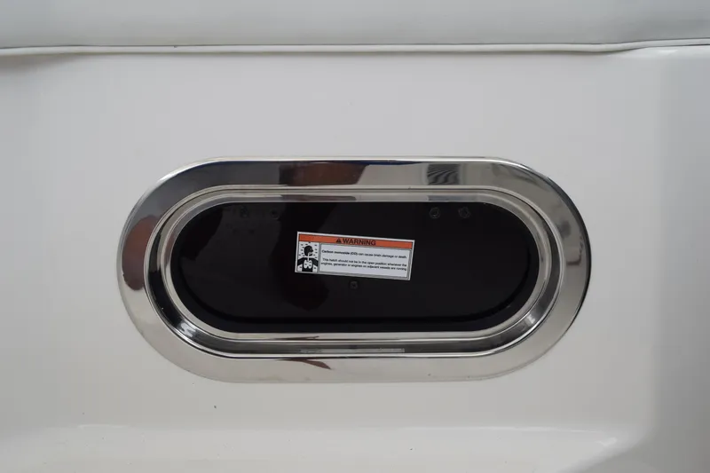 Slide: The Image of Oval window with warning label on 2022 Pursuit OS 355 Offshore boat. - 243