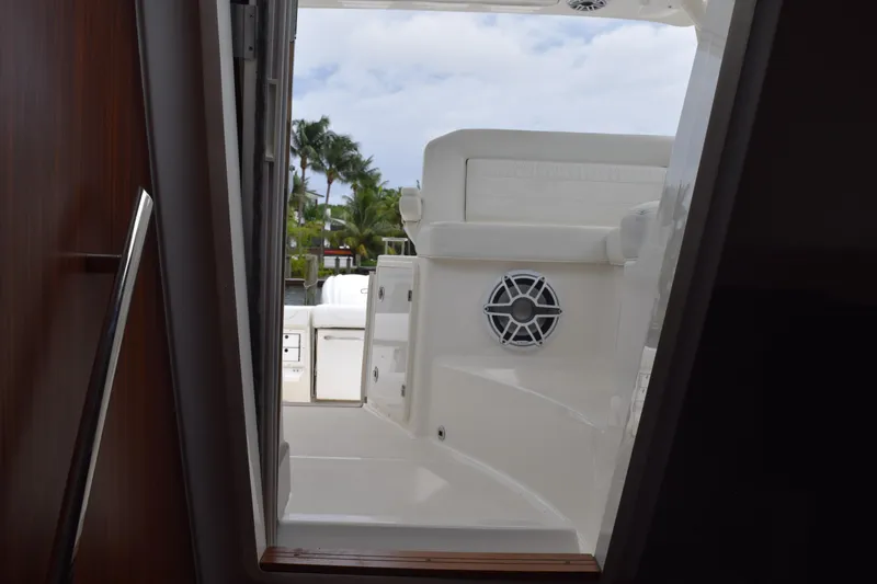 Slide: The Image of 2022 Pursuit OS 355 Offshore boat interior view with seating and speaker. - 343