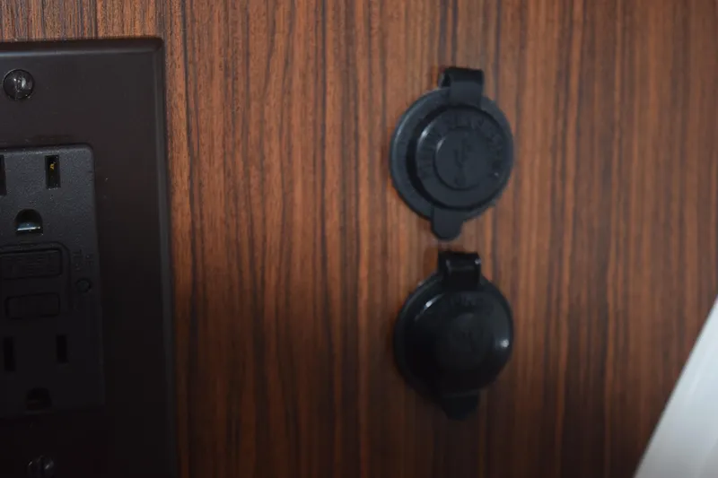 Slide: The Image of Power outlets on 2022 Pursuit OS 355 Offshore boat interior. - 442