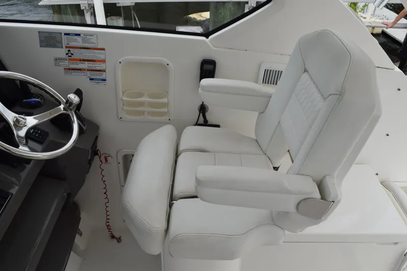 Slide: The Image of Captain's chair and steering wheel on 2022 Pursuit OS 355 Offshore boat. - 251