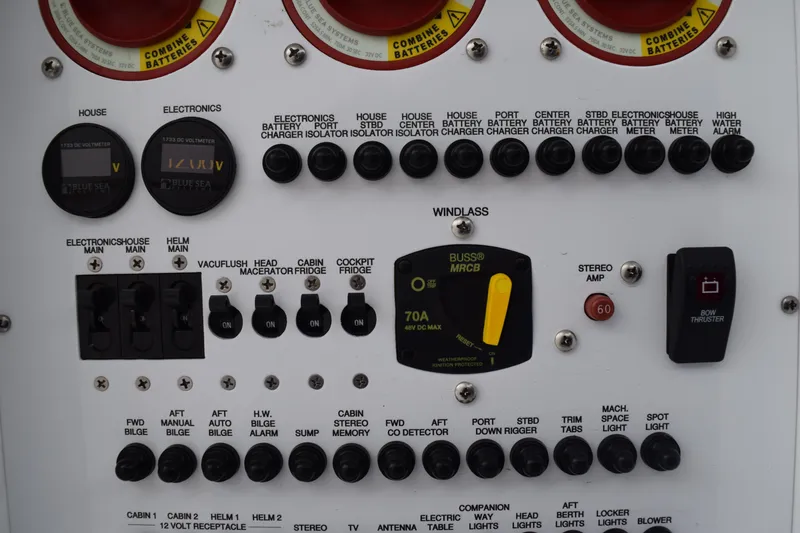 Slide: The Image of Control panel of a 2022 Pursuit OS 355 Offshore boat with various switches and indicators. - 169