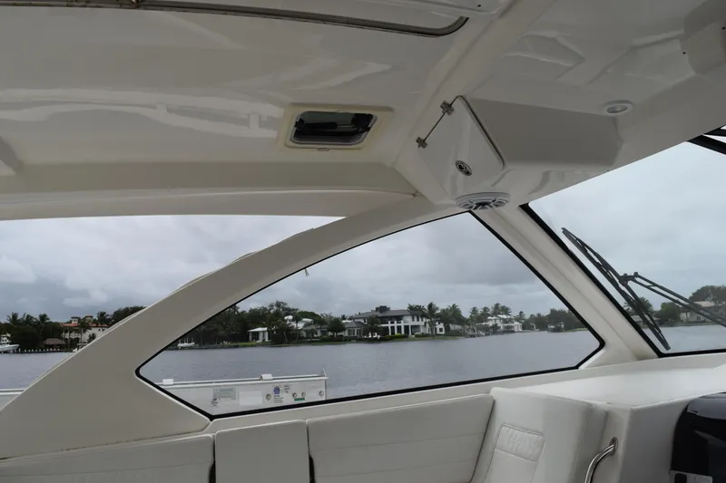 Slide: The Image of Interior view of 2022 Pursuit OS 355 Offshore boat with waterfront scenery. - 306