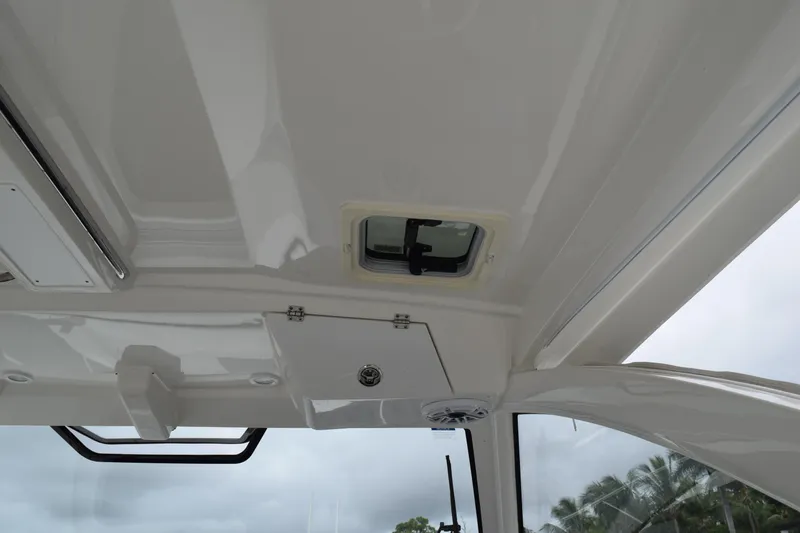 Slide: The Image of 2022 Pursuit OS 355 Offshore boat interior ceiling with hatch and speaker. - 199
