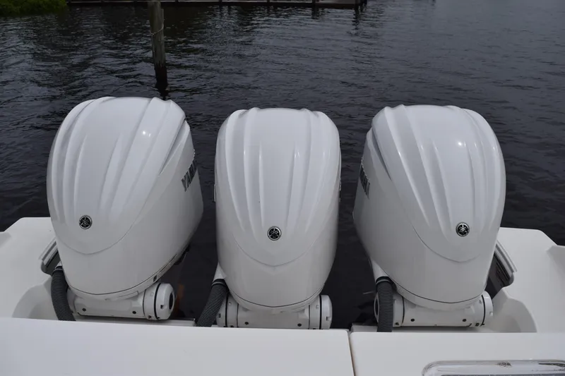 Slide: The Image of Triple Yamaha outboard engines on a 2022 Pursuit OS 355 Offshore boat. - 68