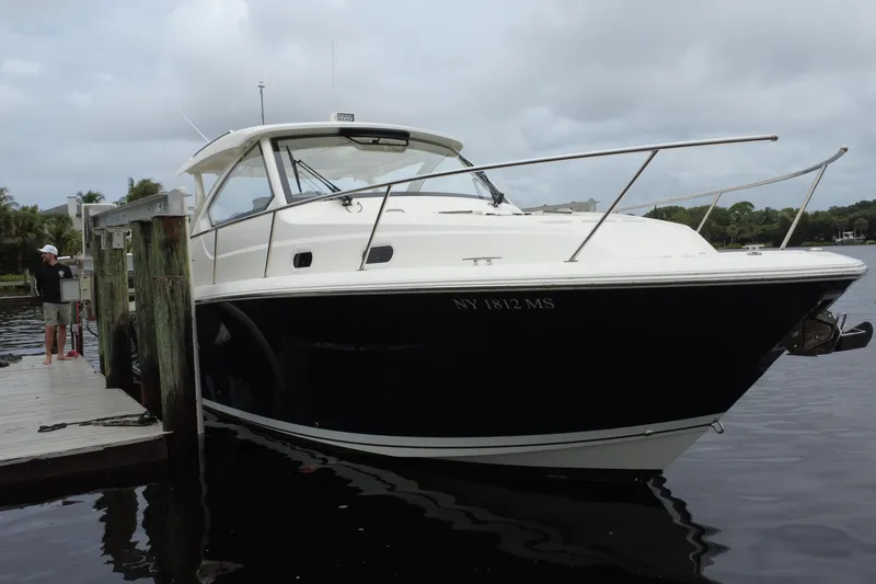 Slide: The Image of 2022 Pursuit OS 355 Offshore boat docked on a cloudy day. - 465