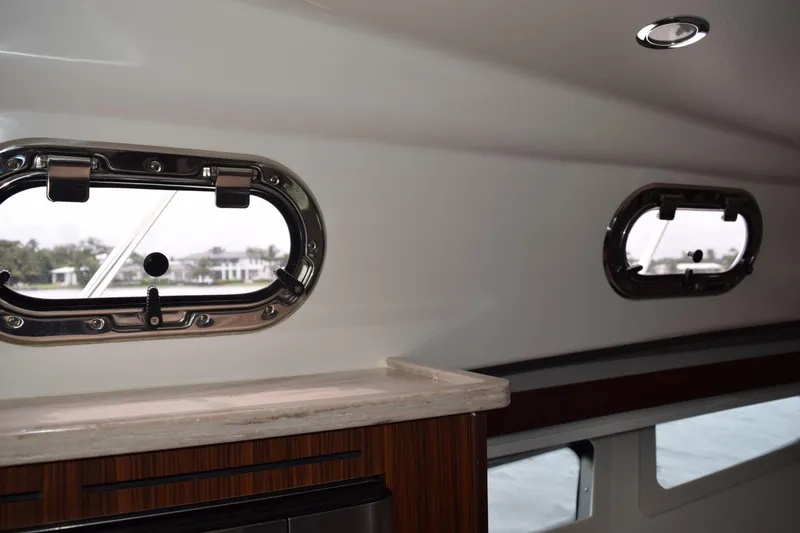 Slide: The Image of Interior view of 2022 Pursuit OS 355 Offshore yacht with porthole windows. - 394