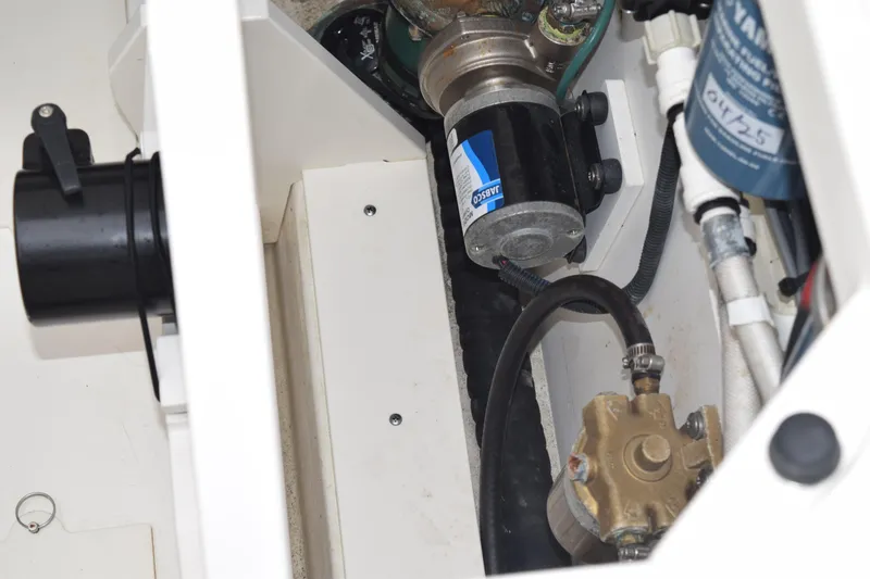 Slide: The Image of Engine compartment of 2022 Pursuit OS 355 Offshore boat, showcasing mechanical components. - 131