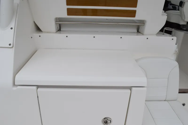 Slide: The Image of 2022 Pursuit OS 355 Offshore boat interior with white seating and storage area. - 186