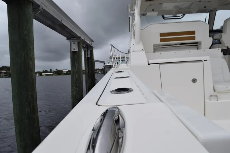 Slide: The Image of 2022 Pursuit OS 355 Offshore boat docked, showcasing sleek design and modern features. - 79