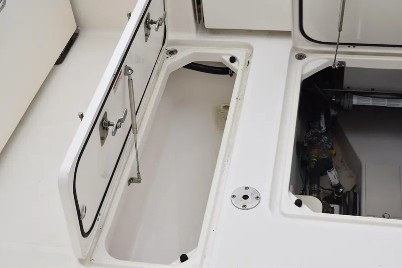 Slide: The Image of 2022 Pursuit OS 355 Offshore boat storage compartments and mechanical access. - 149