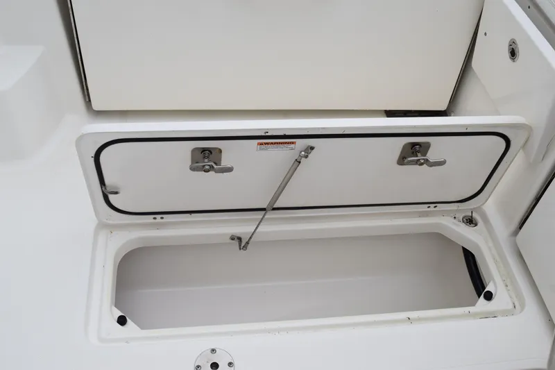 Slide: The Image of 2022 Pursuit OS 355 Offshore storage compartment with open hatch and secure latches. - 139
