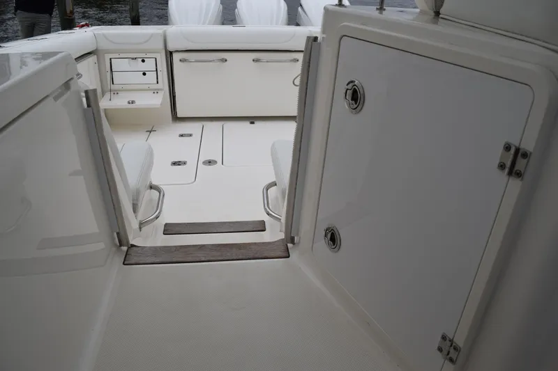 Slide: The Image of 2022 Pursuit OS 355 Offshore boat interior with storage compartments and seating. - 172