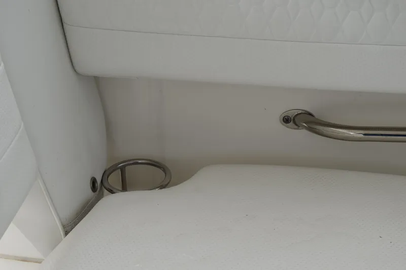 Slide: The Image of Interior detail of 2022 Pursuit OS 355 Offshore boat, featuring white upholstery and metal handle. - 233