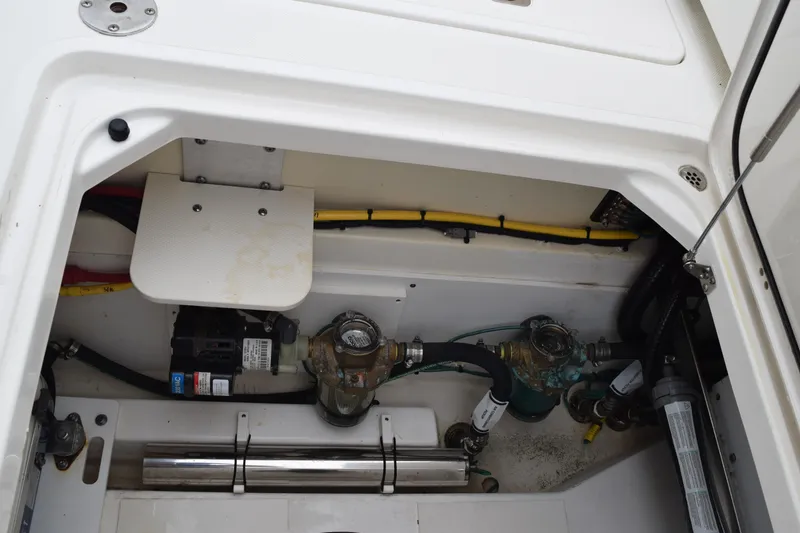 Slide: The Image of 2022 Pursuit OS 355 Offshore engine compartment with visible wiring and components. - 132