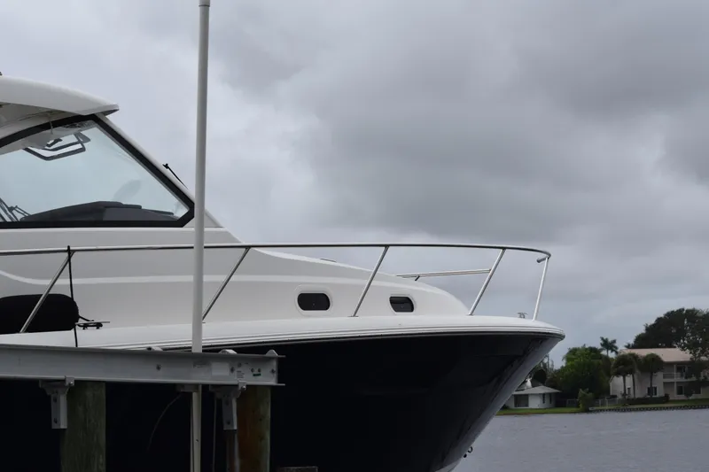 Slide: The Image of 2022 Pursuit OS 355 Offshore boat docked under cloudy skies. - 454