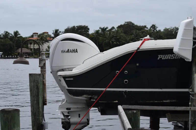 Slide: The Image of 2022 Pursuit OS 355 Offshore boat with Yamaha engine docked by waterfront. - 457