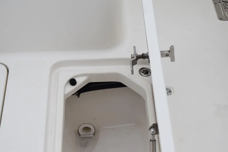 Slide: The Image of 2022 Pursuit OS 355 Offshore boat compartment detail with latch mechanism. - 124