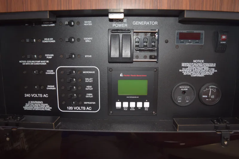 Slide: The Image of Electrical control panel of 2022 Pursuit OS 355 Offshore boat with various switches and gauges. - 414