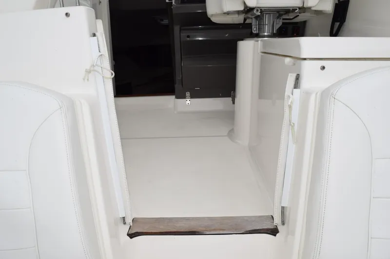 Slide: The Image of 2022 Pursuit OS 355 Offshore boat interior with white seating and helm area. - 163