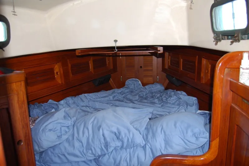 Slide: The Image of Interior cabin of 1981 Bristol 40 Yawl with wooden finish and blue bedding. - 50