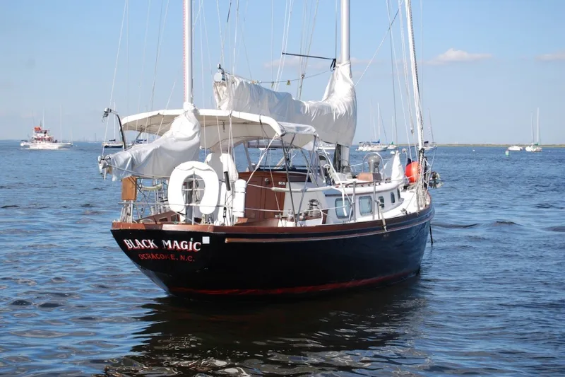Slide: The Image of 1981 Bristol 40 Yawl sailboat named "Black Magic" on calm waters. - 14