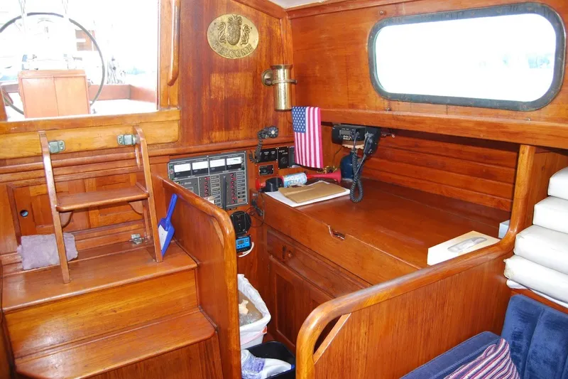 Slide: The Image of Interior of 1981 Bristol 40 Yawl sailboat with wooden cabinetry and navigation equipment. - 36