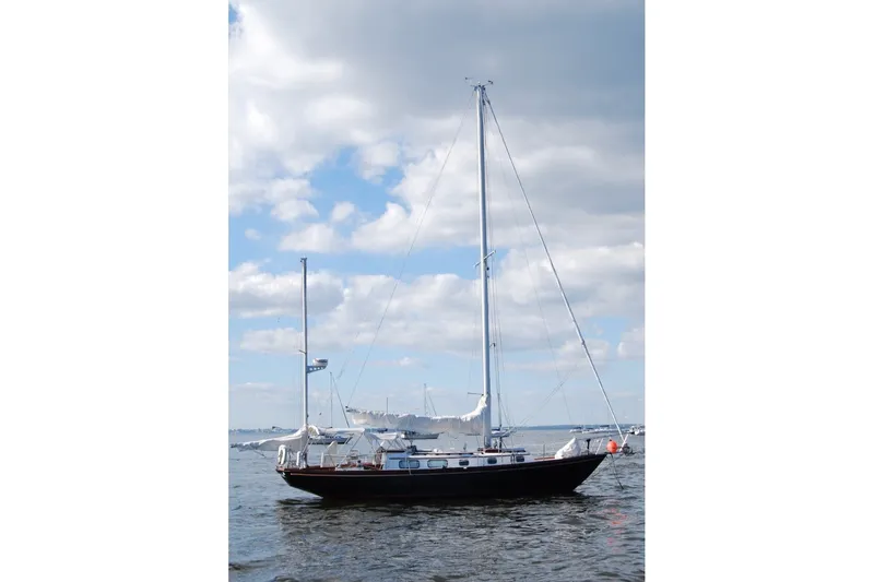 Slide: The Image of 1981 Bristol 40 Yawl sailboat on calm water under a partly cloudy sky. - 7