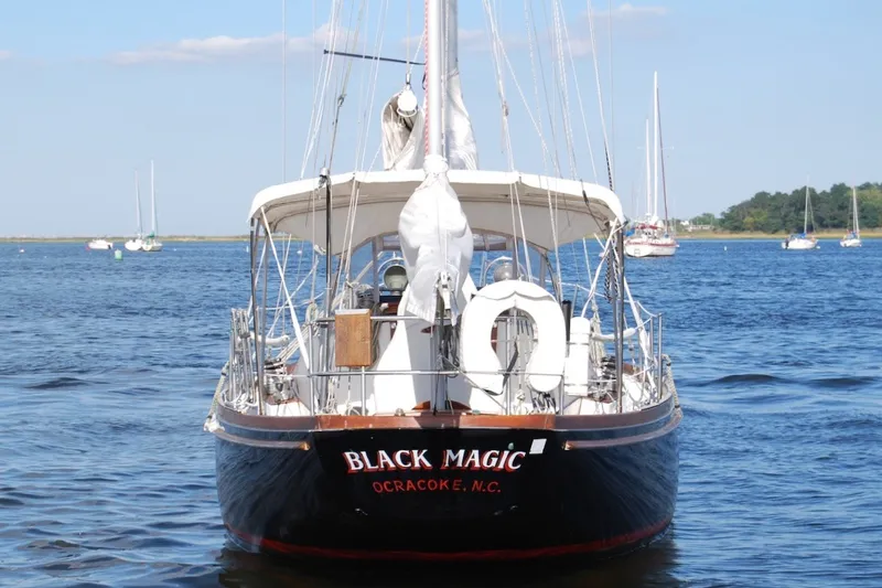 Slide: The Image of 1981 Bristol 40 Yawl sailboat named "Black Magic" on calm water, Ocracoke, N.C. - 15