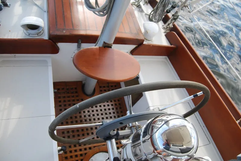 Slide: The Image of Cockpit of 1981 Bristol 40 Yawl sailboat with wooden accents and steering wheel. - 11