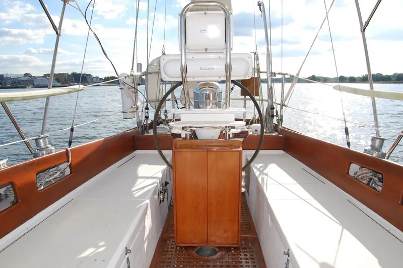 Slide: The Image of 1981 Bristol 40 Yawl sailboat cockpit with wooden accents and dual steering wheels. - 56