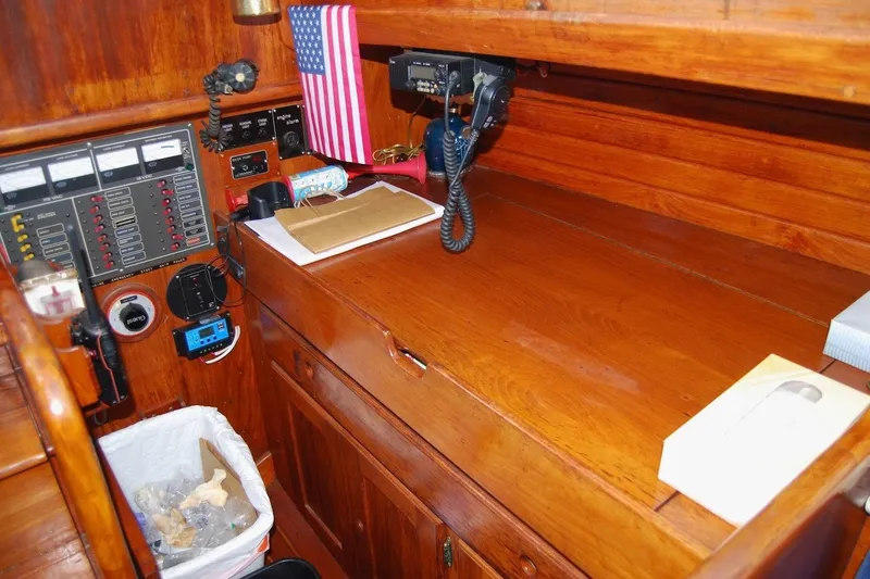 Slide: The Image of Navigation station of a 1981 Bristol 40 Yawl with communication equipment and American flag. - 41
