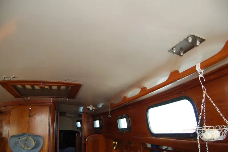 Slide: The Image of Interior of 1981 Bristol 40 Yawl sailboat with wooden paneling and portholes. - 54
