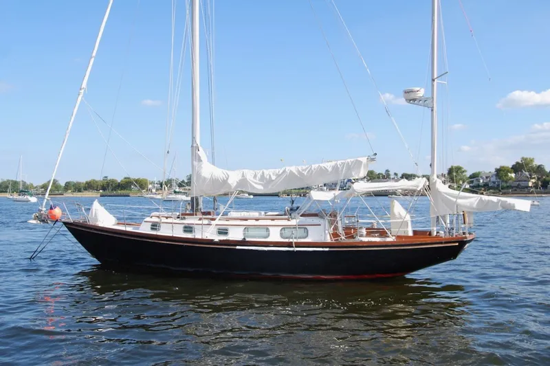 Slide: The Image of 1981 Bristol 40 Yawl sailboat on calm water, featuring classic design and white sails. - 9