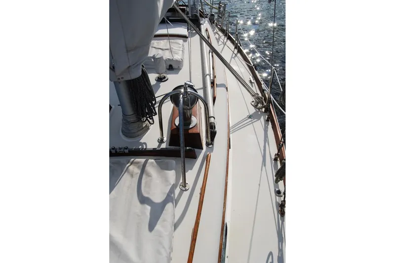 Slide: The Image of 1981 Bristol 40 Yawl sailboat deck with rigging and sunlight reflections on water. - 34