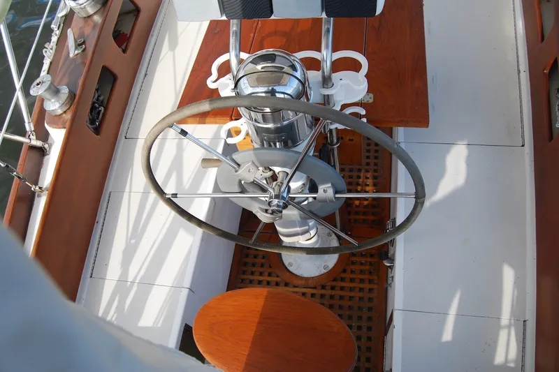 Slide: The Image of Cockpit of 1981 Bristol 40 Yawl sailboat with wooden and metal steering wheel. - 21