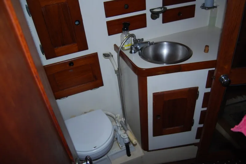 Slide: The Image of Interior of 1981 Bristol 40 Yawl bathroom with wooden cabinets and stainless steel sink. - 51
