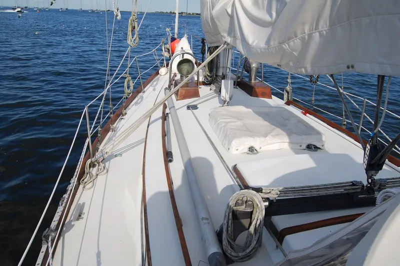 Slide: The Image of 1981 Bristol 40 Yawl sailboat deck with rigging, moored on calm water. - 33