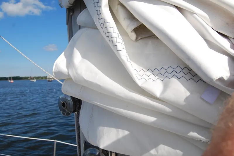 Slide: The Image of Folded sail on a 1981 Bristol 40 Yawl, with blue sky and water background. - 35
