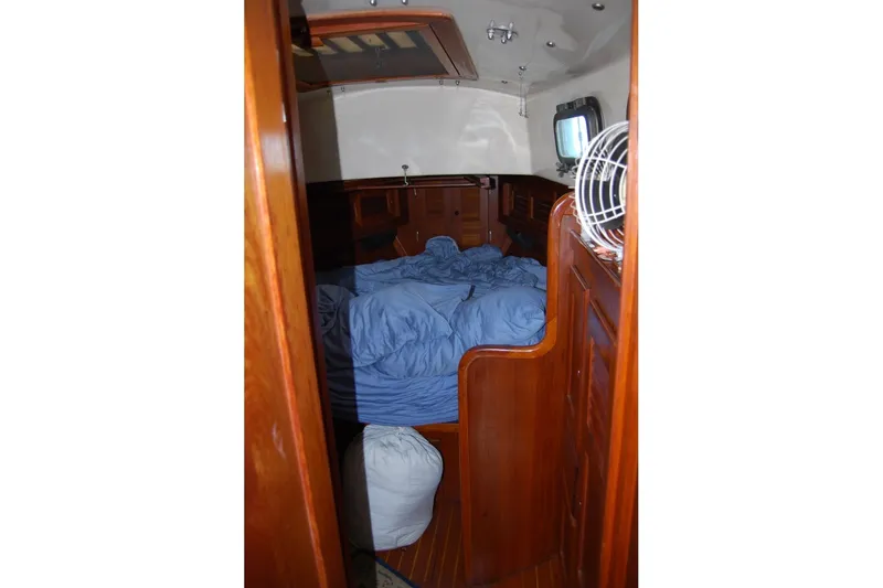 Slide: The Image of Cozy cabin interior of 1981 Bristol 40 Yawl sailboat with wooden finish and blue bedding. - 44