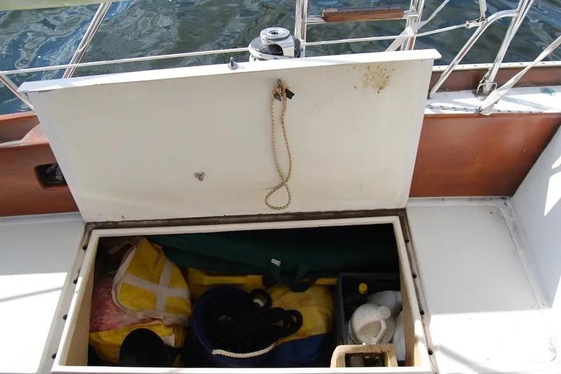 Slide: The Image of Open storage compartment on 1981 Bristol 40 Yawl sailboat, containing ropes and supplies. - 18