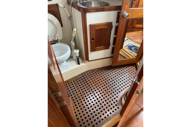 Slide: The Image of 1981 Bristol 40 Yawl bathroom with wooden cabinetry and nautical design elements. - 13