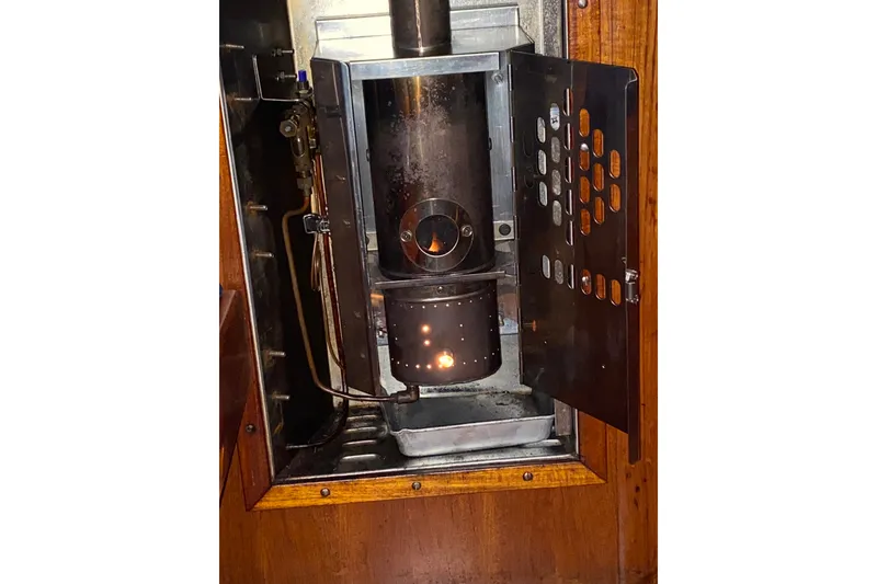 Slide: The Image of 1981 Bristol 40 Yawl interior stove with open door, showcasing vintage nautical design. - 14