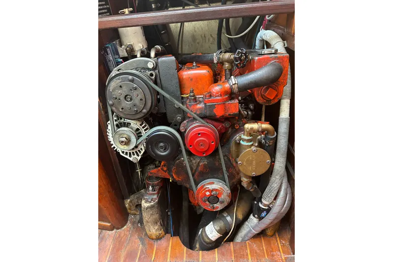 Slide: The Image of Engine of a 1981 Bristol 40 Yawl sailboat, showcasing mechanical components and hoses. - 15