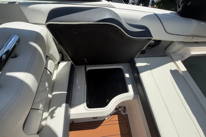 Slide: The Image of 2022 Regal LS2 boat interior with open storage compartment and white seating. - 29