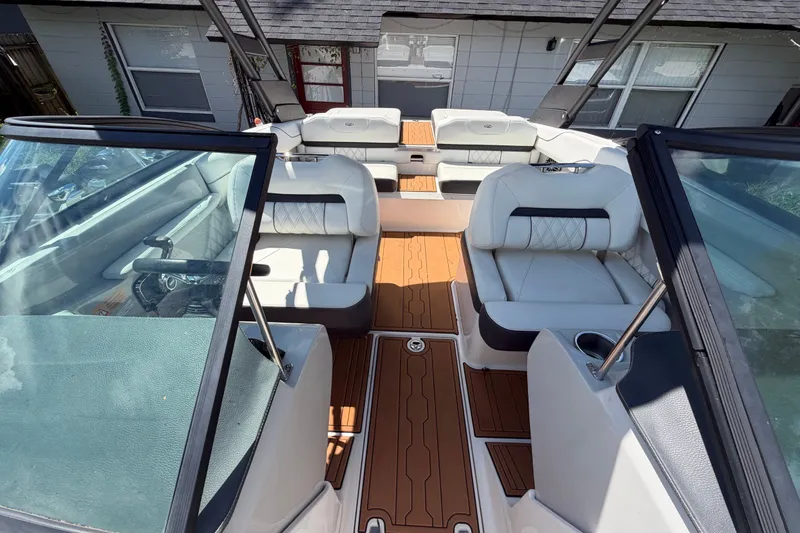 Slide: The Image of Interior view of a 2022 Regal LS2 boat with luxurious seating and wood-style flooring. - 35