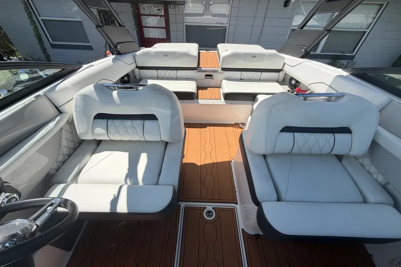 Slide: The Image of 2022 Regal LS2 boat interior with white leather seating and teak flooring. - 36