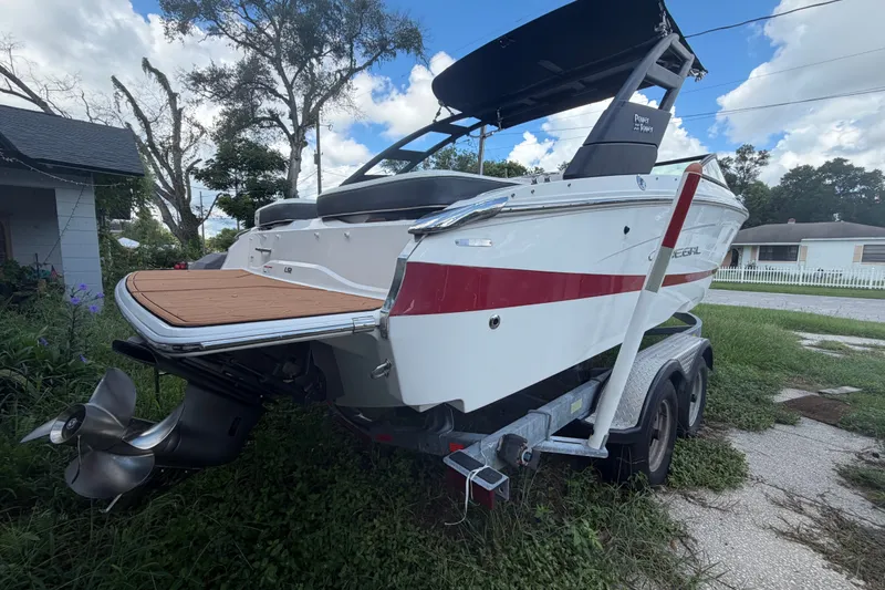 Slide: The Image of 2022 Regal LS2 boat on trailer, featuring sleek design and red stripe accents. - 6