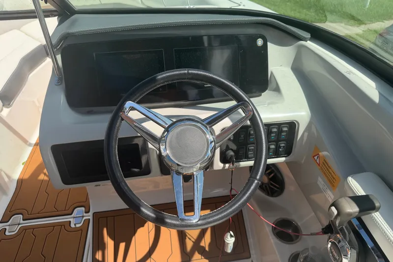 Slide: The Image of 2022 Regal LS2 boat dashboard with steering wheel and control panel. - 24