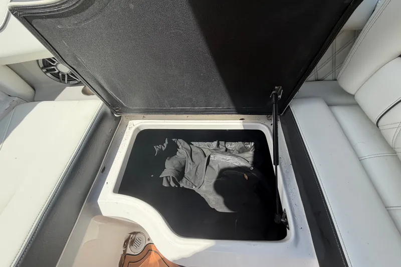 Slide: The Image of Open storage compartment in a 2022 Regal LS2 boat, showing interior space. - 30